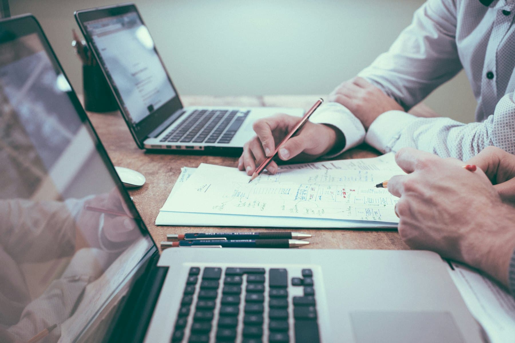 Documents and a laptop on a desk during a consultation